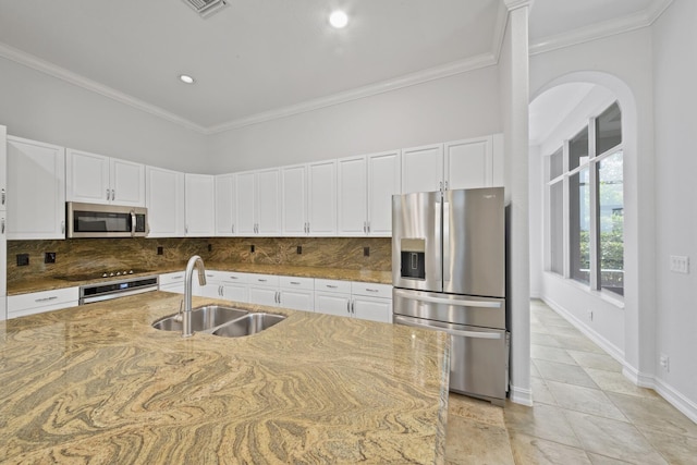 12520 NW 79th Mnr, Parkland, FL 33076 - kitchen featuring light stone counters, a sink, backsplash, and stainless steel appliances
