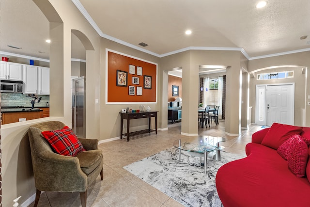 living room with ornamental molding and light tile patterned flooring