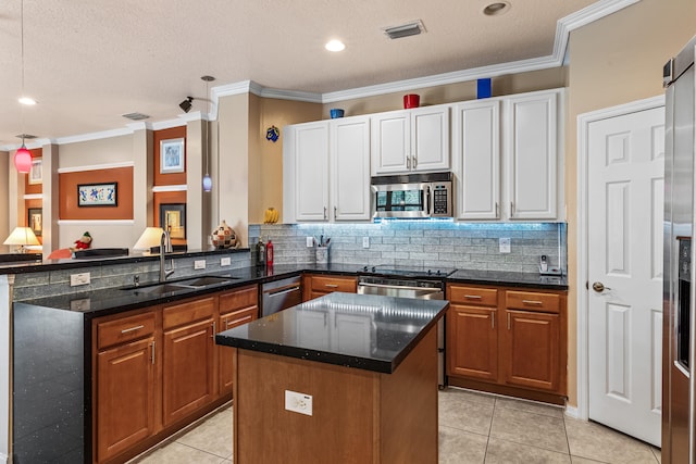 kitchen with appliances with stainless steel finishes, a center island, sink, white cabinetry, and light tile patterned flooring