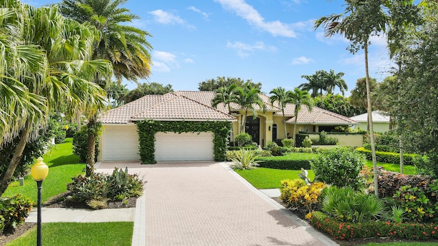 mediterranean / spanish-style home with a garage