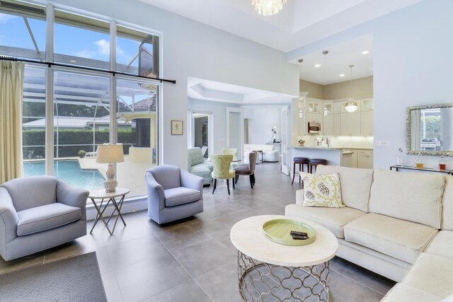 kitchen with a tray ceiling, decorative light fixtures, and stainless steel appliances