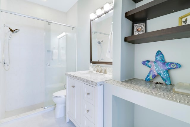 bathroom with vanity, toilet, tile patterned flooring, and a shower with door