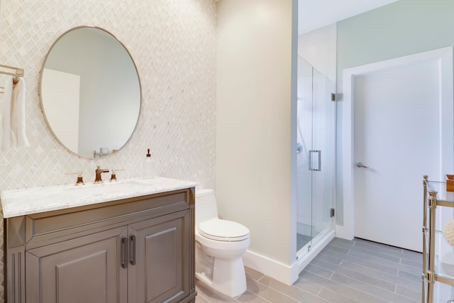 bathroom featuring vanity, toilet, walk in shower, and tile patterned flooring