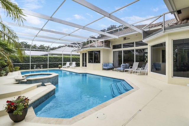 view of swimming pool with a patio area, an in ground hot tub, ceiling fan, and a lanai