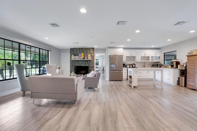 living room featuring light hardwood / wood-style flooring and a fireplace