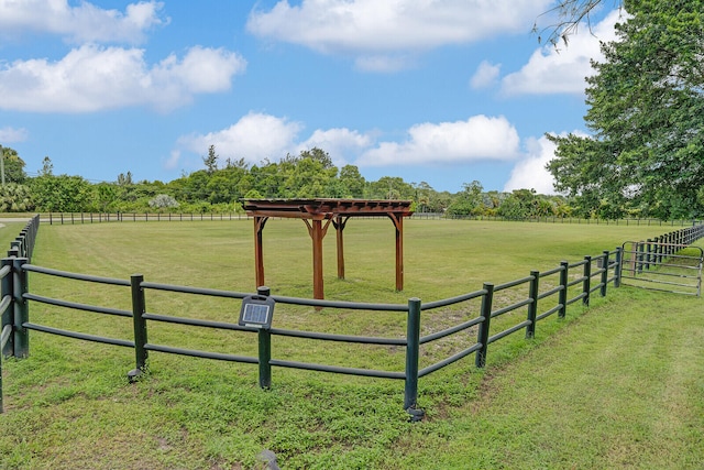 view of yard featuring a rural view and a pergola