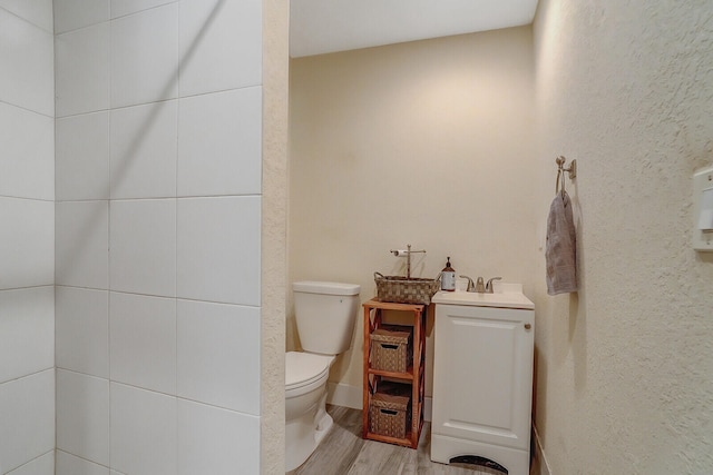 bathroom featuring hardwood / wood-style floors, toilet, and vanity