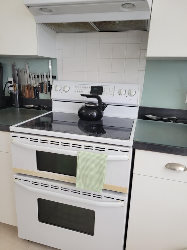 kitchen with white cabinets, ventilation hood, electric range, decorative backsplash, and light tile patterned floors