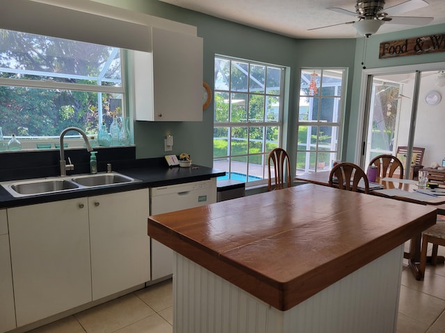 kitchen with white cabinetry, a wealth of natural light, and sink