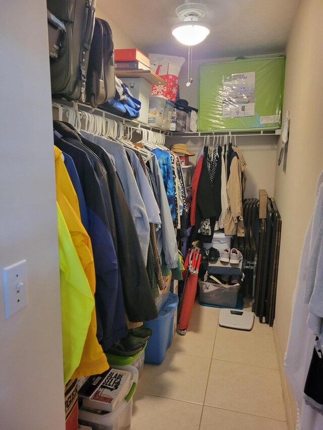 walk in closet with tile patterned flooring