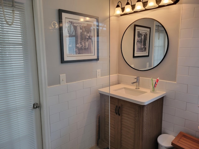 bathroom featuring vanity and tile walls