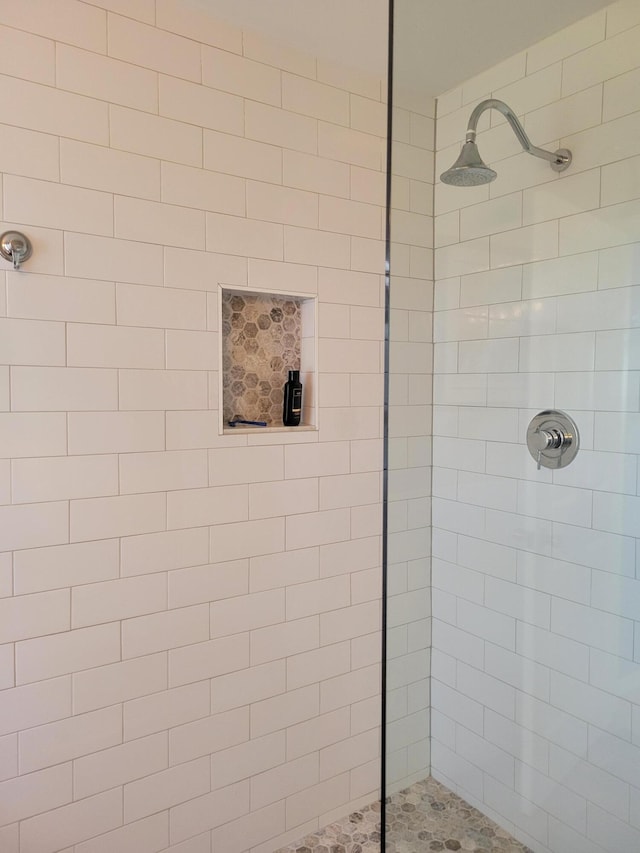 bathroom with a tile shower