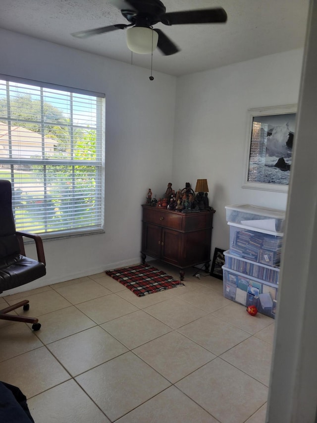 office area with ceiling fan and light tile patterned flooring