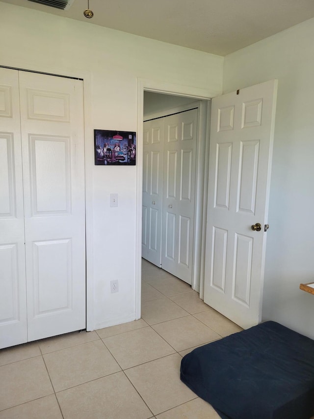 unfurnished bedroom featuring light tile patterned flooring