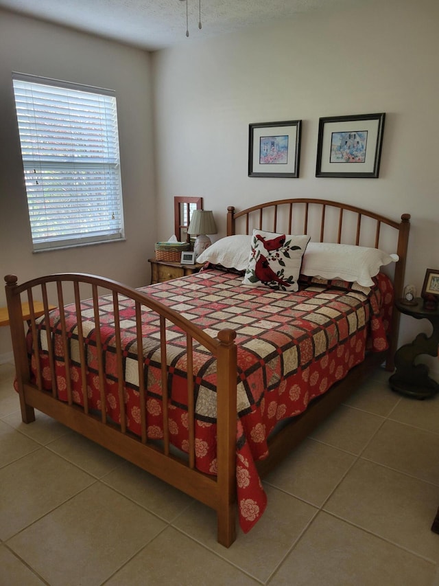 bedroom with tile patterned flooring and a textured ceiling