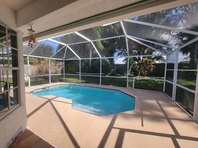 view of swimming pool with a lanai and a patio