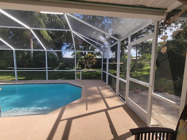 view of swimming pool with a lanai and a patio