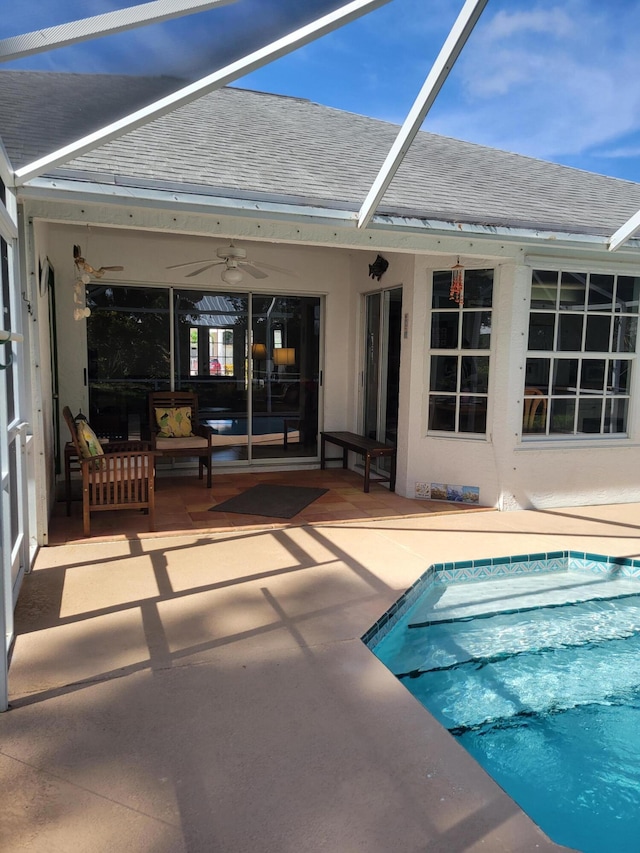 view of swimming pool with a lanai, a patio area, and ceiling fan