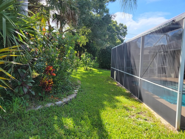 view of yard with glass enclosure