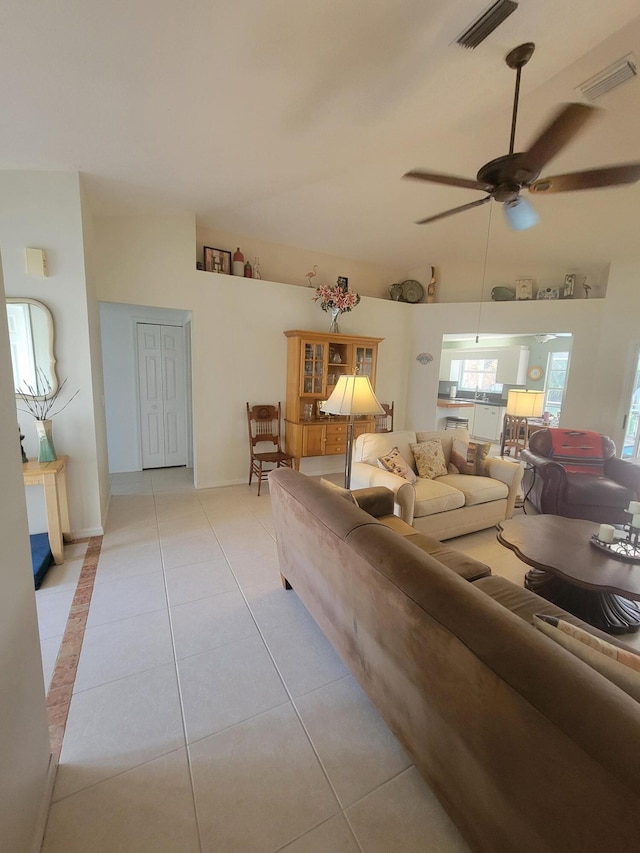 living room featuring ceiling fan and light tile patterned flooring