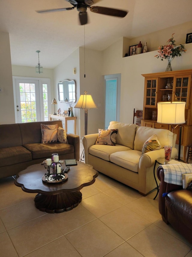 tiled living room featuring ceiling fan and lofted ceiling