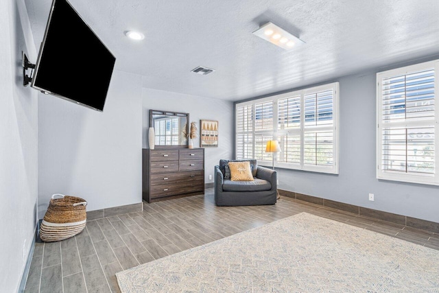 sitting room featuring hardwood / wood-style flooring and a textured ceiling