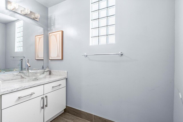 bathroom featuring vanity, a wealth of natural light, and tile patterned floors