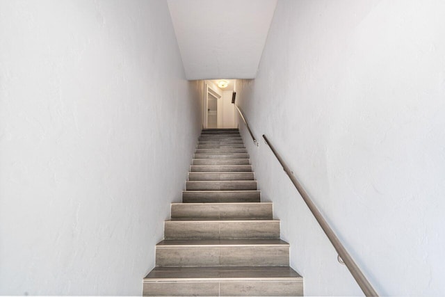 stairway featuring wood finished floors