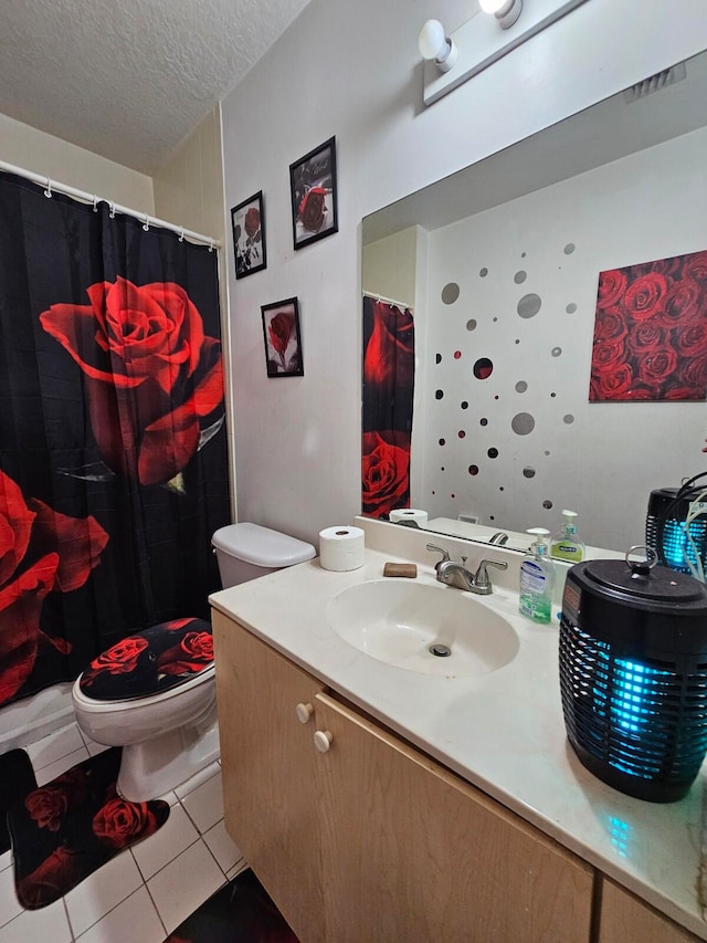 bathroom featuring toilet, walk in shower, tile patterned flooring, vanity, and a textured ceiling