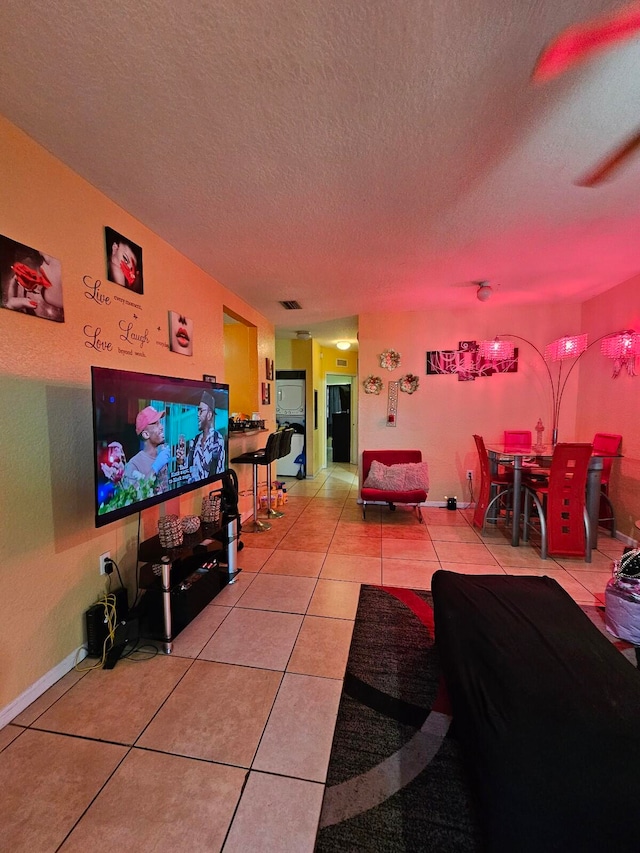 tiled living room with a textured ceiling