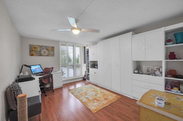 office space with a textured ceiling, ceiling fan, and dark hardwood / wood-style floors