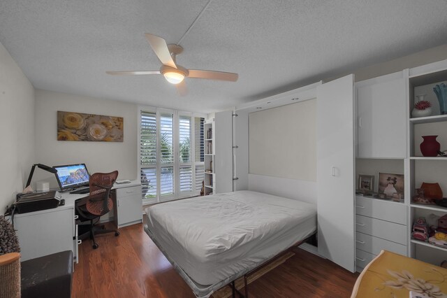 bedroom with ceiling fan, dark hardwood / wood-style floors, and a textured ceiling