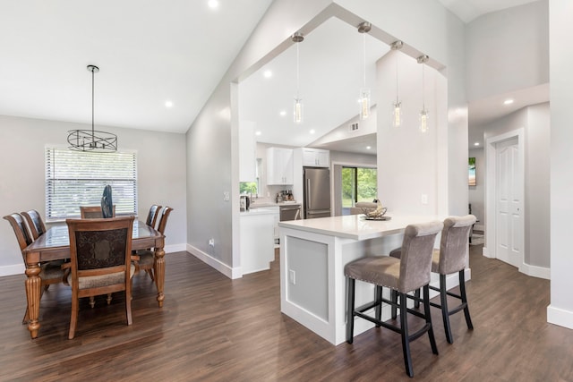 kitchen featuring white cabinets, dark hardwood / wood-style flooring, and hanging light fixtures