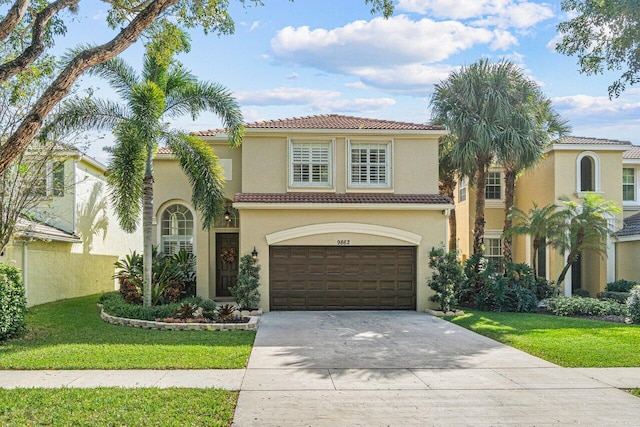 mediterranean / spanish-style home with a garage and a front yard