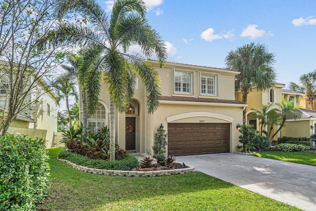 mediterranean / spanish-style house with a garage and a front yard