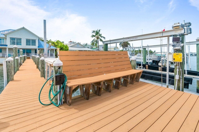 wooden terrace featuring a boat dock and a water view