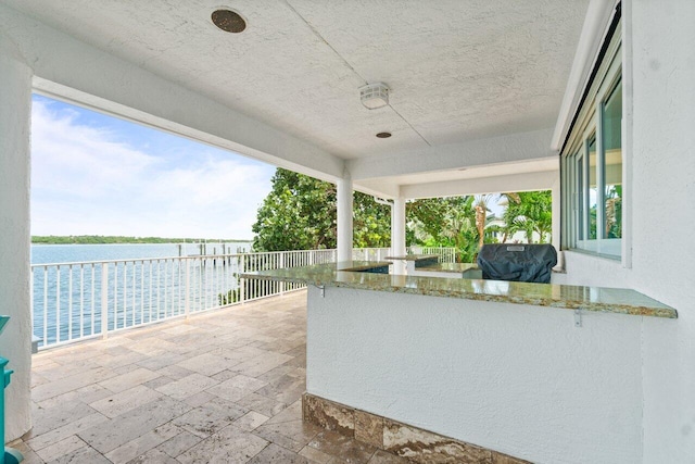 view of patio / terrace with a water view and grilling area