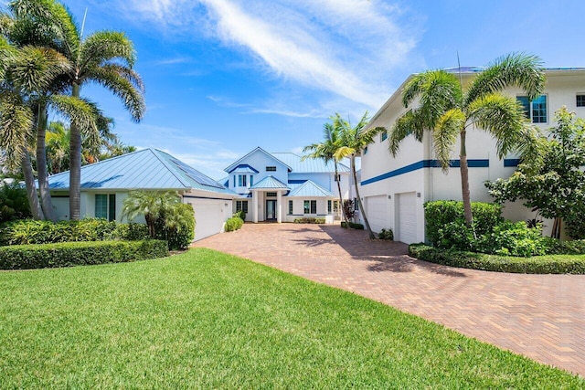 view of front of house featuring a garage and a front lawn