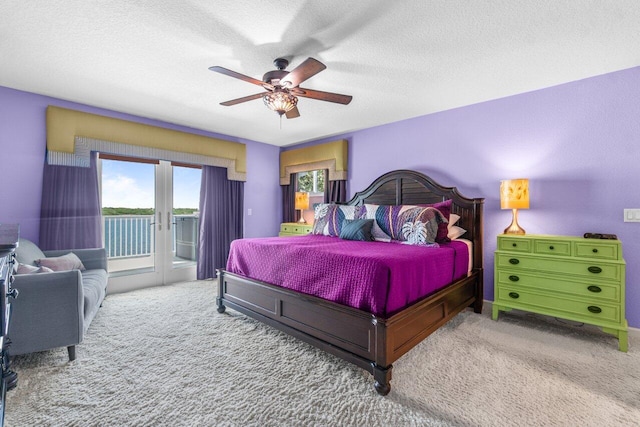 bedroom with a textured ceiling, access to exterior, ceiling fan, and carpet floors