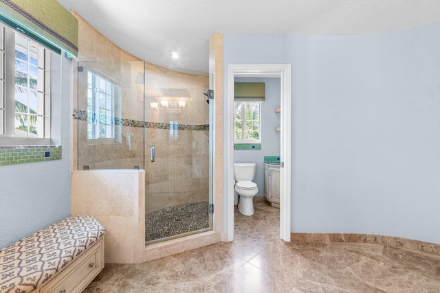 bathroom with toilet and walk in shower