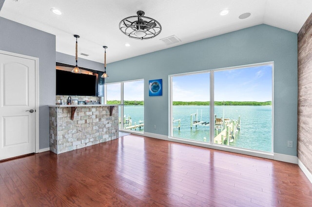 unfurnished living room with lofted ceiling, hardwood / wood-style flooring, and ceiling fan