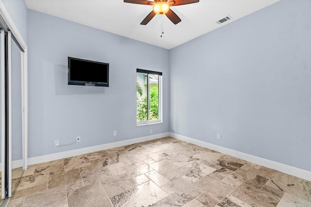 interior space with ceiling fan