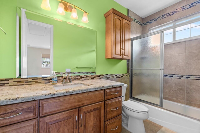 full bathroom with vanity, toilet, enclosed tub / shower combo, and decorative backsplash