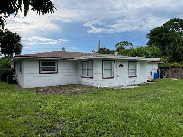 single story home with a front lawn and central air condition unit