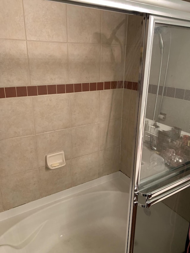 bathroom with a shower with door