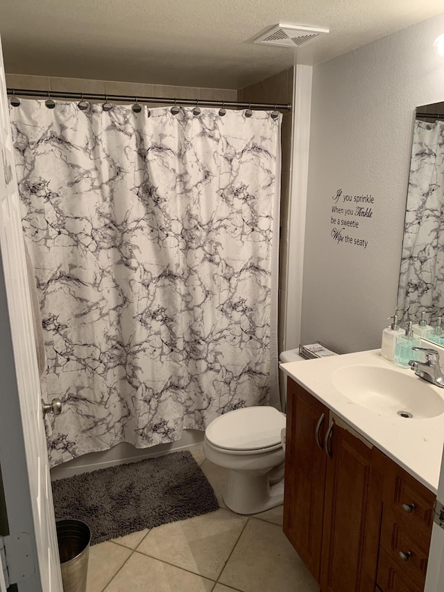 bathroom featuring visible vents, toilet, a textured ceiling, a shower with shower curtain, and vanity