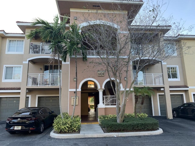 view of property featuring an attached garage and driveway