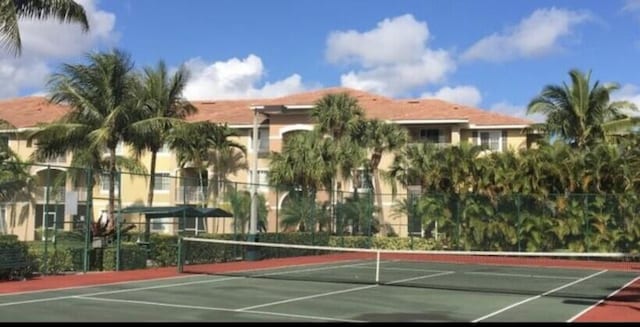 view of sport court featuring fence