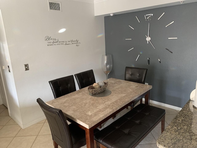 dining space featuring light tile patterned flooring, visible vents, and baseboards