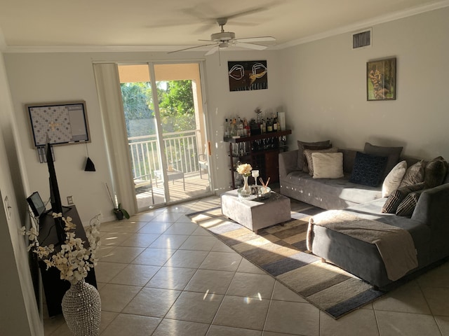 living room with crown molding, visible vents, tile patterned floors, and ceiling fan